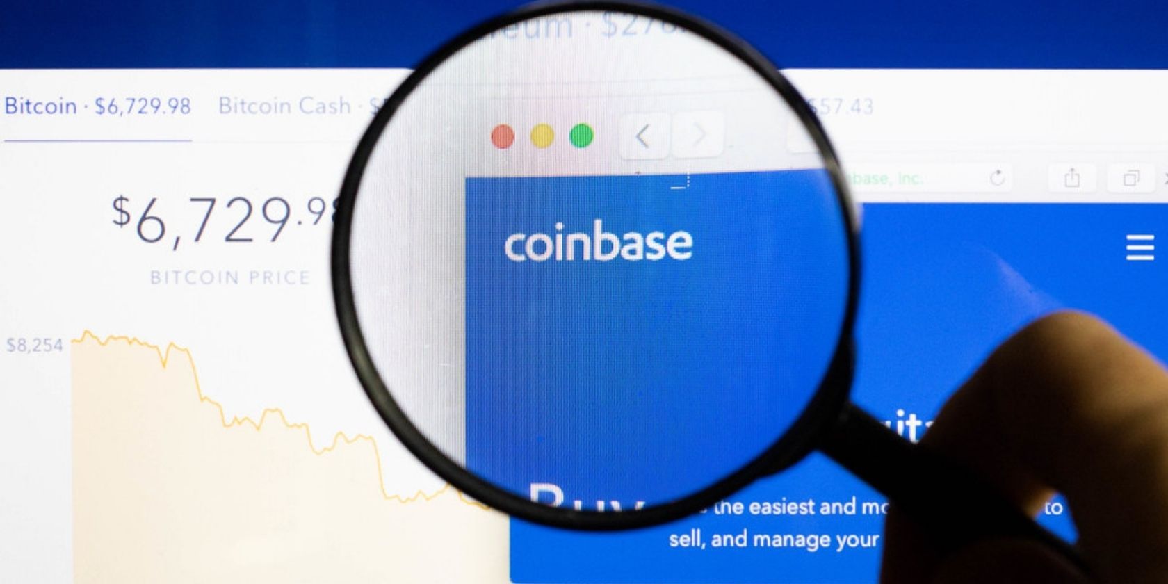 coinbase website behind magnifying glass