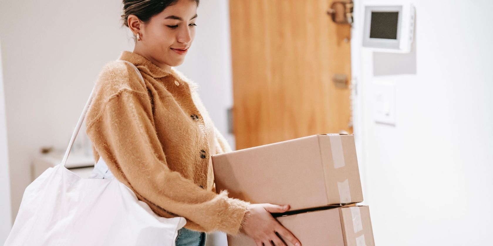 smiling woman with two packages ready to ship